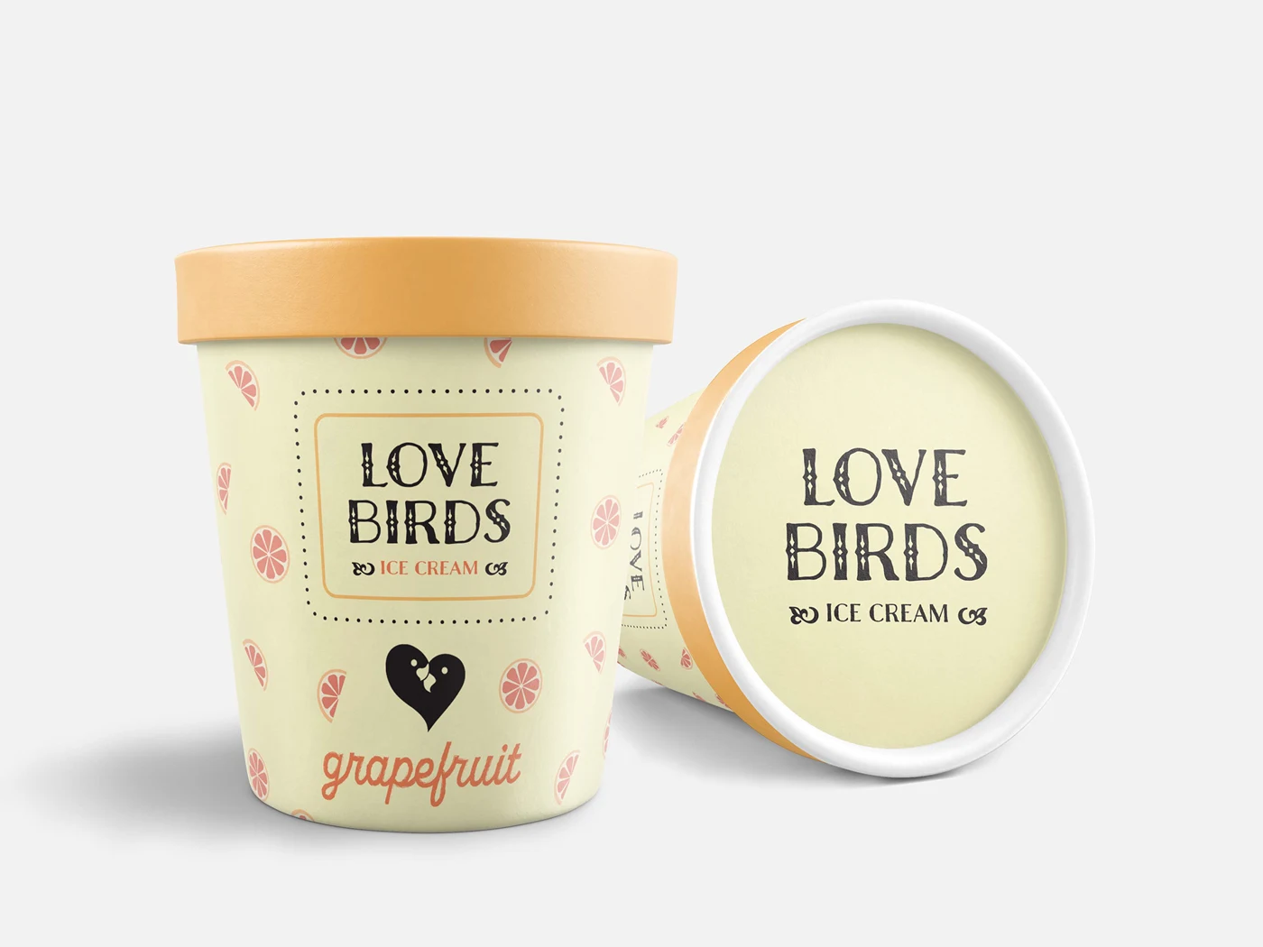Love Birds grapefruit ice cream pint beside a tipped-over pint showing the logo on the lid